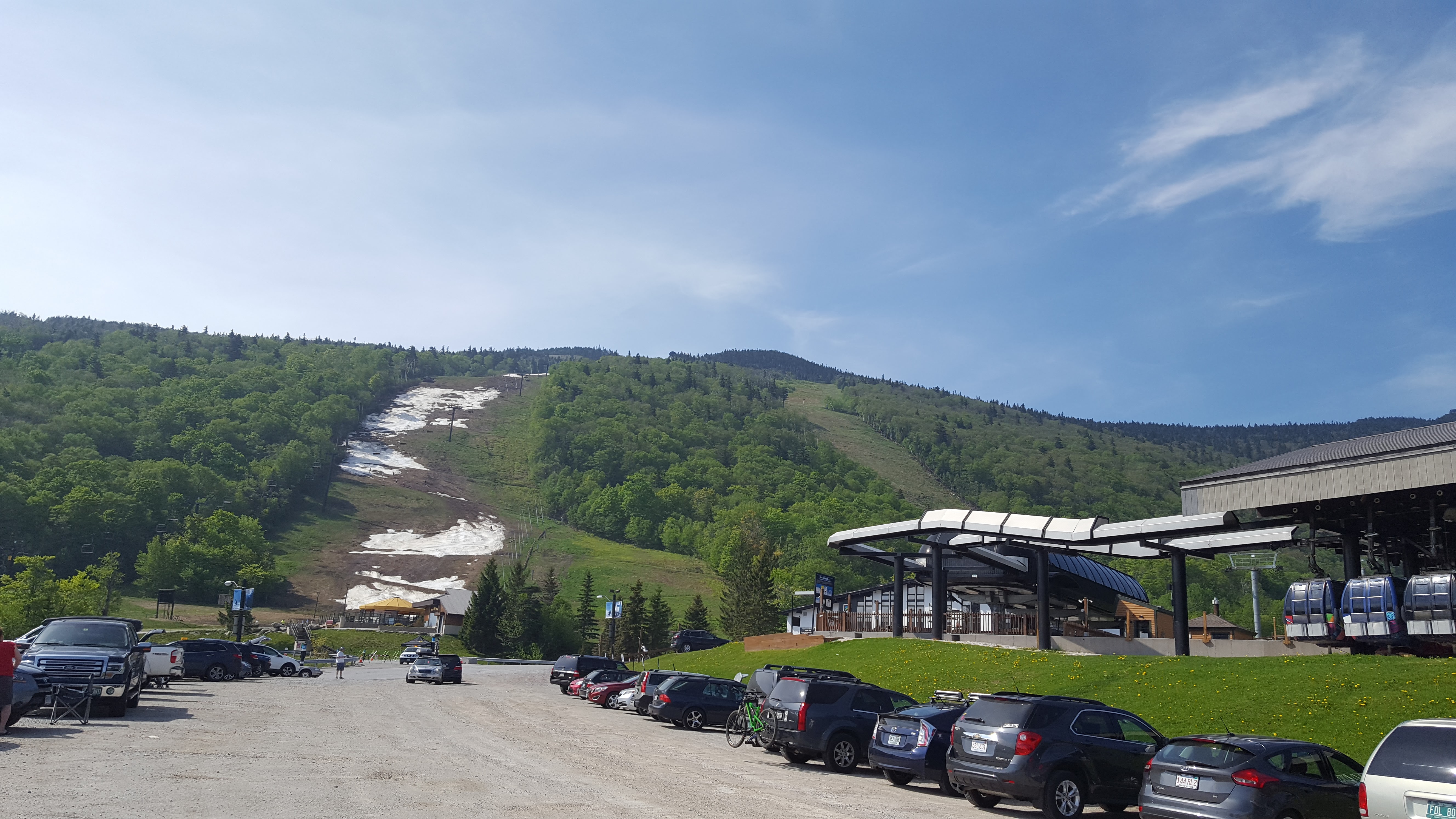 view of Killington's Superstar trail and lift from the parking lot in mid-spring